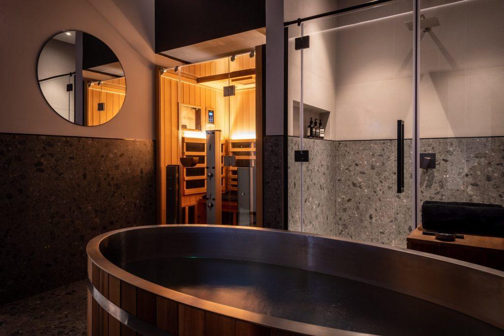 Private contrast therapy suite with cold plunge tub and infrared sauna at Beit Sisu