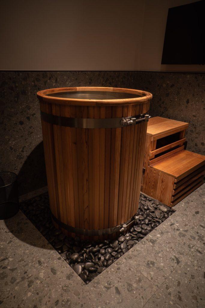 Cedar barrel cold plunge in a private suite at Beit Sisu, Dubai Media City